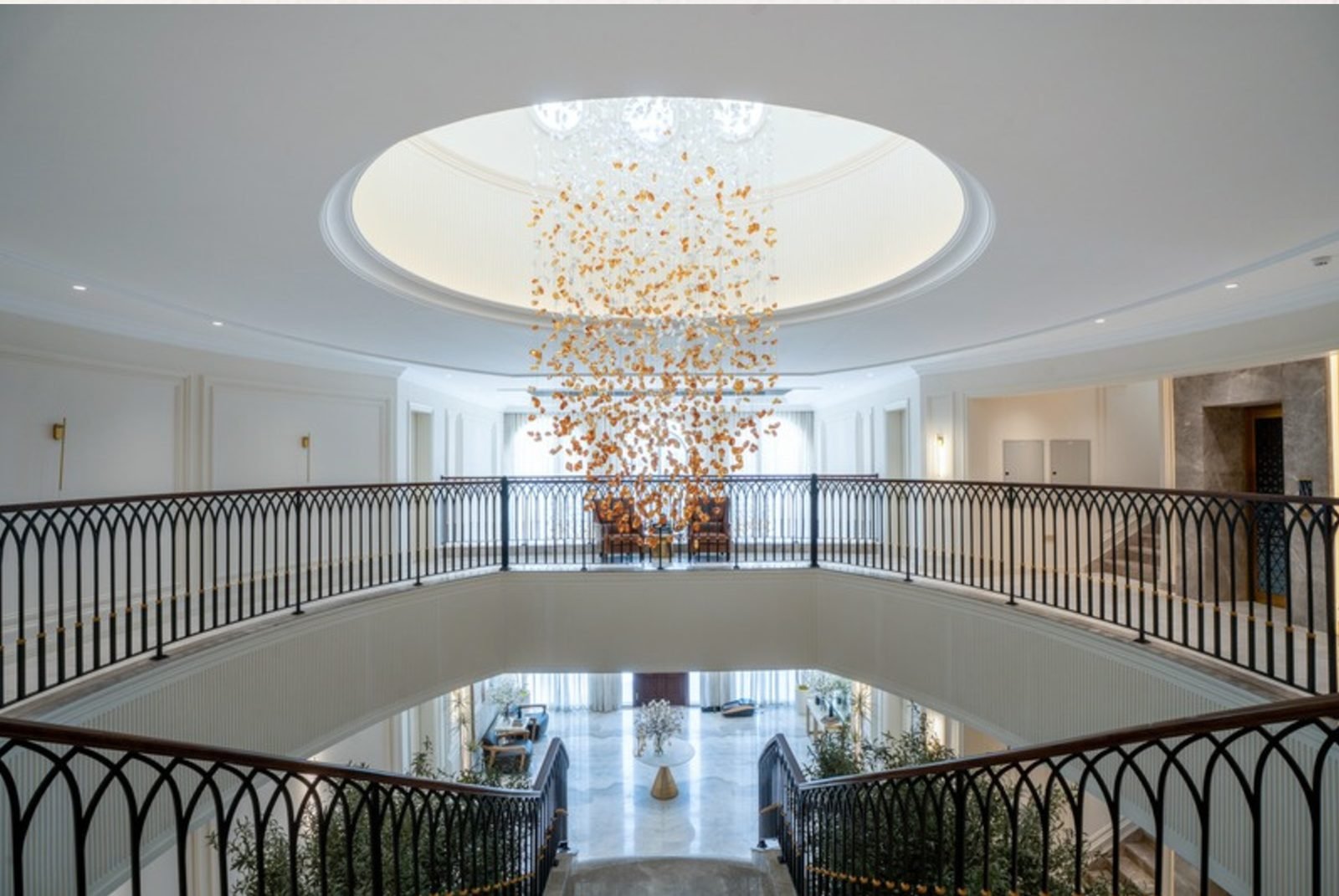 Double-height foyer with suspended chandelier